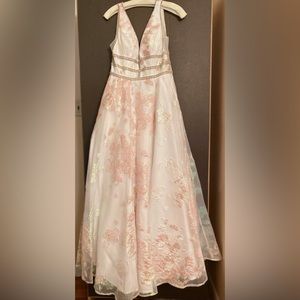 Prom dress by Ellie Wilde. Size 0/2. It is white with sheer iridescent overlay.